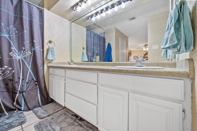 bathroom featuring double vanity, tile patterned floors, ceiling fan, and curtained shower