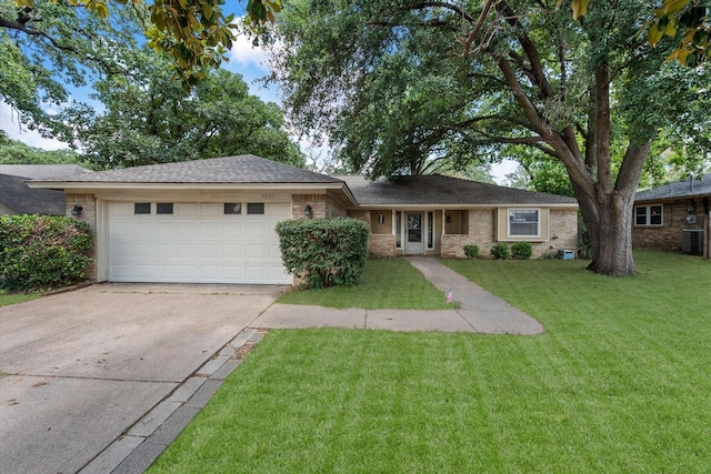 ranch-style house with a garage, concrete driveway, a front lawn, brick siding, and cooling unit
