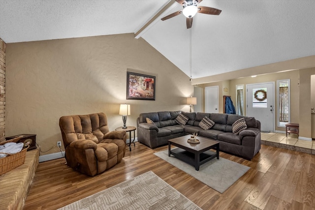 living area with a ceiling fan, wood finished floors, baseboards, and a textured ceiling