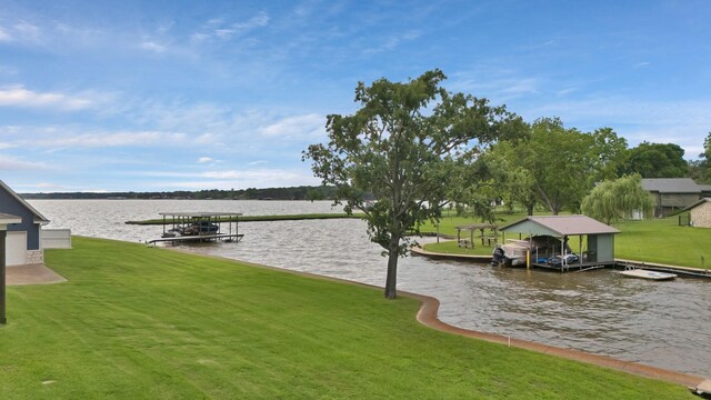 dock area with a yard and a water view