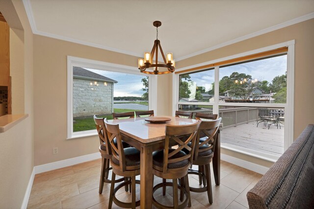 dining space featuring a chandelier, baseboards, crown molding, and light tile patterned floors