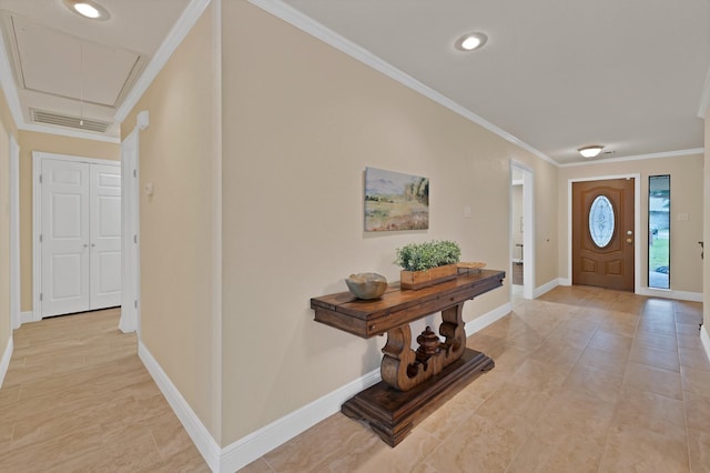foyer with crown molding, baseboards, and recessed lighting