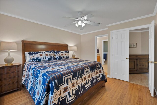 bedroom with light wood finished floors, ornamental molding, baseboards, ceiling fan, and connected bathroom