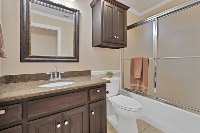 bathroom with ornamental molding, toilet, vanity, tile patterned floors, and shower / bath combination with glass door