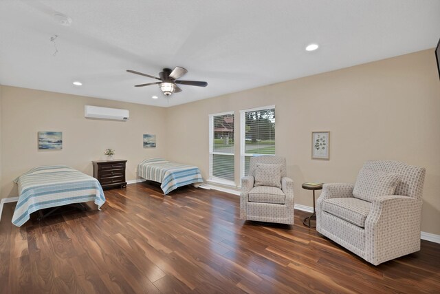 bedroom with a wall mounted air conditioner, wood finished floors, baseboards, recessed lighting, and a ceiling fan