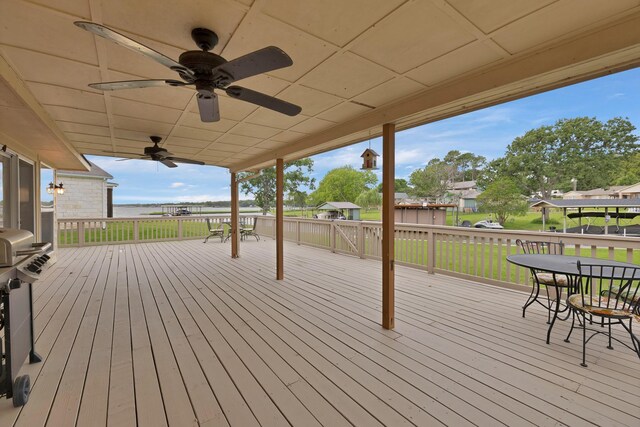 wooden terrace featuring a ceiling fan and outdoor dining space