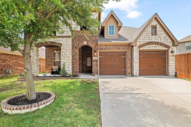 6273 El Capitan St, Fort Worth, TX 76179 - view of front of home with an attached garage, driveway, roof with shingles, brick siding, and stone siding