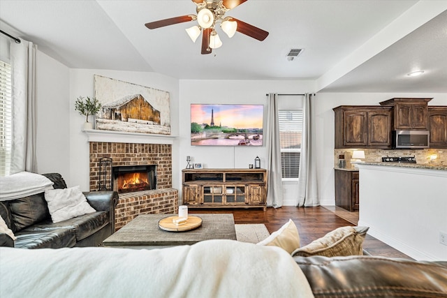 6273 El Capitan St, Fort Worth, TX 76179 - living area featuring a ceiling fan, dark wood finished floors, a fireplace, and baseboards