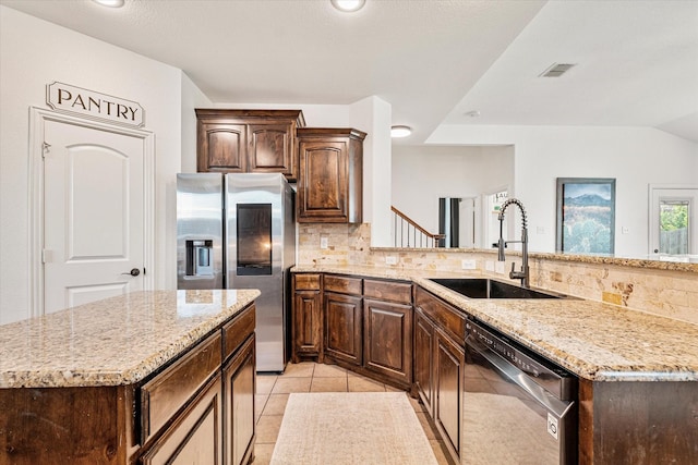 6273 El Capitan St, Fort Worth, TX 76179 - kitchen featuring dishwasher, a sink, stainless steel refrigerator with ice dispenser, decorative backsplash, and lofted ceiling