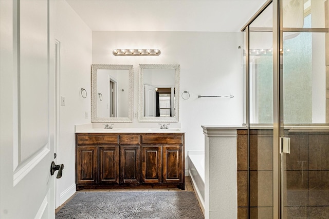6273 El Capitan St, Fort Worth, TX 76179 - bathroom featuring a garden tub, baseboards, a shower stall, and double vanity