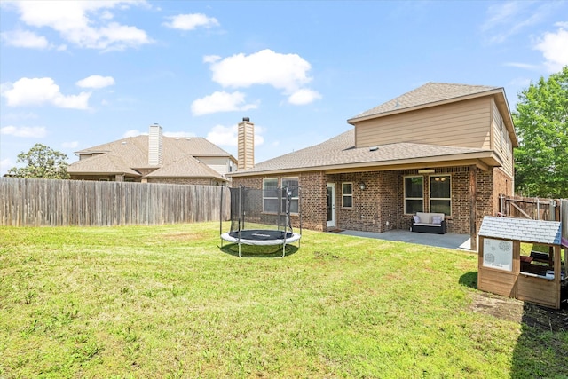 6273 El Capitan St, Fort Worth, TX 76179 - back of property featuring a trampoline, a patio, brick siding, and a shingled roof