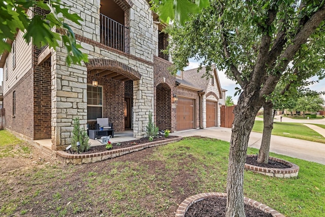 6273 El Capitan St, Fort Worth, TX 76179 - view of side of home with brick siding, an attached garage, driveway, and a lawn