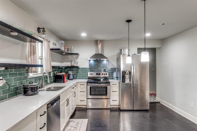 kitchen with stainless steel appliances, wall chimney range hood, open shelves, a sink, and tasteful backsplash