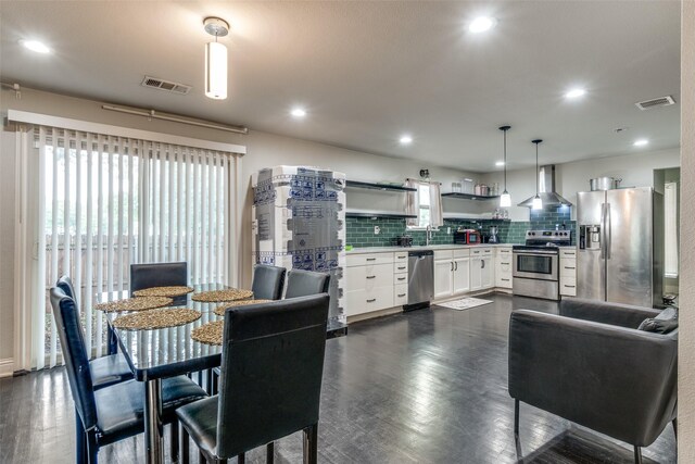 dining area featuring dark wood-style flooring and recessed lighting
