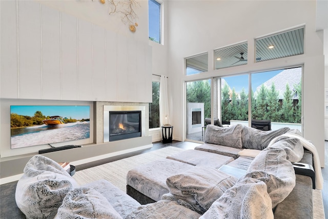 3520 Valmur Ave, Colleyville, TX 76034 - living area with a high ceiling, baseboards, wood finished floors, and a glass covered fireplace