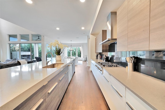 3520 Valmur Ave, Colleyville, TX 76034 - kitchen featuring a sink, wall chimney range hood, stainless steel gas cooktop, modern cabinets, and recessed lighting