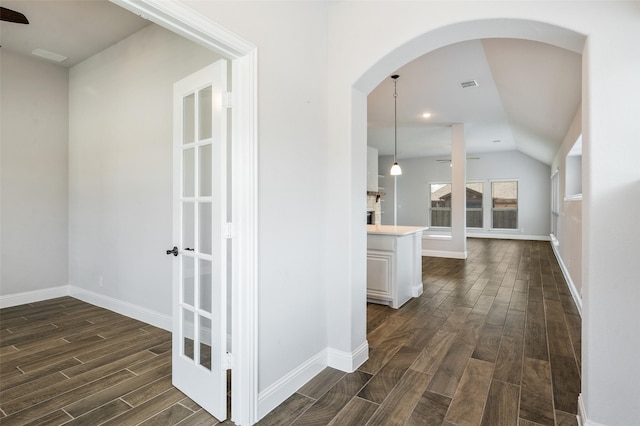 9117 Amistad Ln, Denton, TX 76226 - corridor featuring dark wood-type flooring, baseboards, arched walkways, and vaulted ceiling