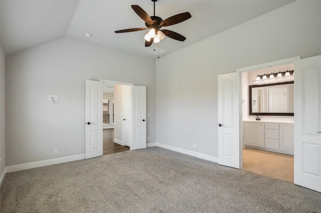 9117 Amistad Ln, Denton, TX 76226 - unfurnished bedroom with light colored carpet, baseboards, ensuite bath, lofted ceiling, and a ceiling fan