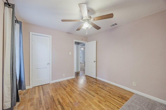 unfurnished bedroom with baseboards, light wood-style flooring, and a ceiling fan