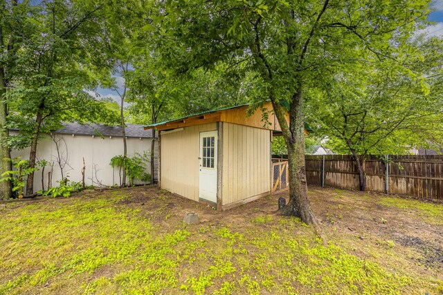 view of shed featuring fence