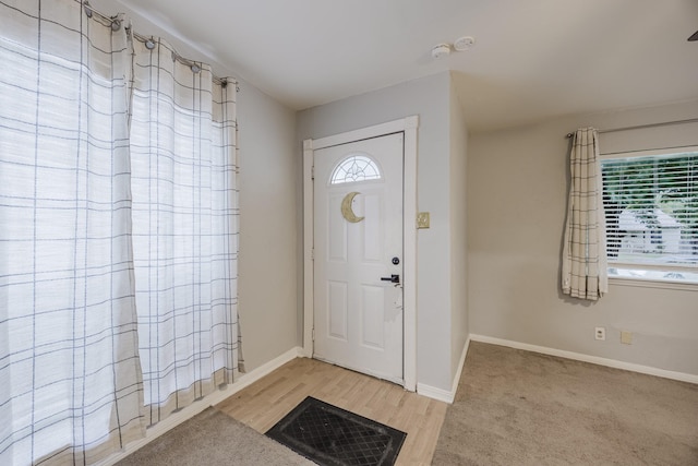 foyer featuring baseboards and light wood-style flooring