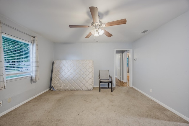 unfurnished bedroom with carpet, baseboards, and a ceiling fan