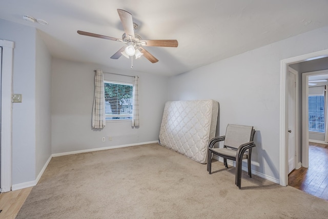 unfurnished room with a ceiling fan, carpet floors, and baseboards