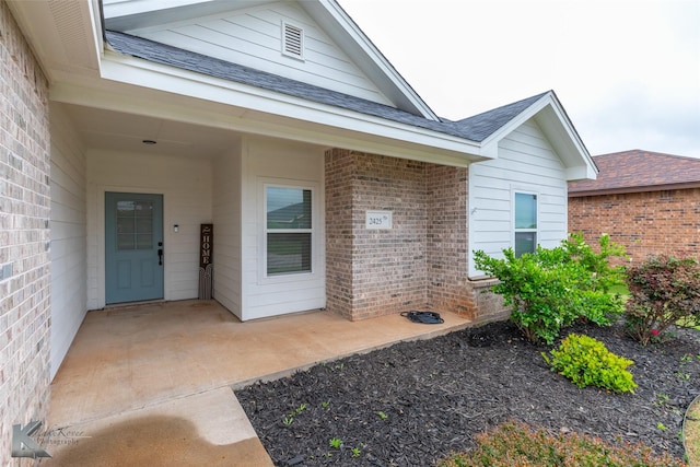 2425 Plymouth Rock Rd, Abilene, TX 79601 - entrance to property featuring brick siding and a shingled roof
