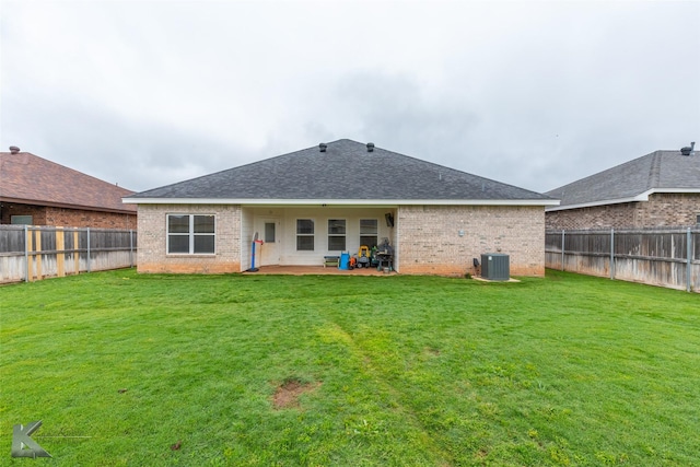 2425 Plymouth Rock Rd, Abilene, TX 79601 - back of property featuring brick siding, central AC, a patio, and a shingled roof