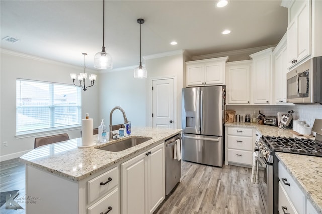 2425 Plymouth Rock Rd, Abilene, TX 79601 - kitchen with appliances with stainless steel finishes, a sink, crown molding, white cabinetry, and light wood-style flooring