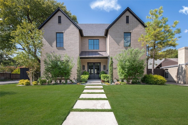 6905 Northridge Dr, Dallas, TX 75214 - view of front of house with french doors, a front lawn, brick siding, and a standing seam roof