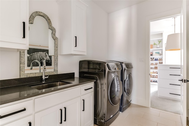 6905 Northridge Dr, Dallas, TX 75214 - washroom featuring cabinet space, washer and clothes dryer, and light tile patterned flooring