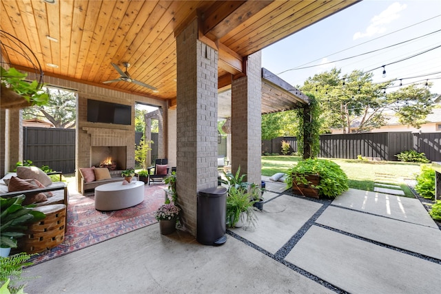 6905 Northridge Dr, Dallas, TX 75214 - view of patio with a fenced backyard, an outdoor living space with a fireplace, and ceiling fan