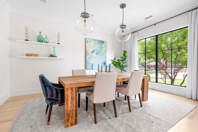 6905 Northridge Dr, Dallas, TX 75214 - dining space featuring light wood-style flooring, crown molding, and baseboards