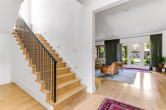 6905 Northridge Dr, Dallas, TX 75214 - staircase with wood finished floors, baseboards, crown molding, and french doors