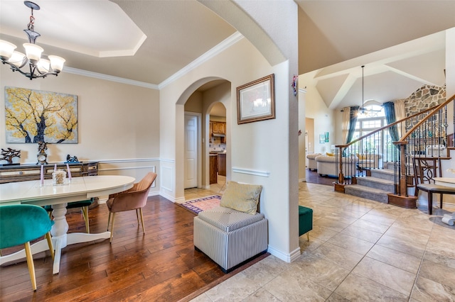 314 Trakehner Trl, Celina, TX 75009 - dining space with a chandelier, stairs, arched walkways, ornamental molding, and wood finished floors