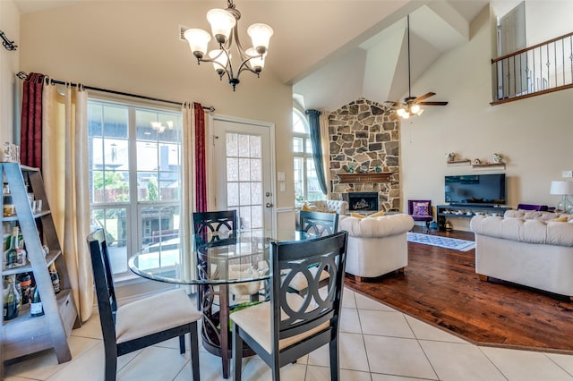 314 Trakehner Trl, Celina, TX 75009 - dining area featuring a chandelier, light tile patterned floors, a fireplace, high vaulted ceiling, and ceiling fan
