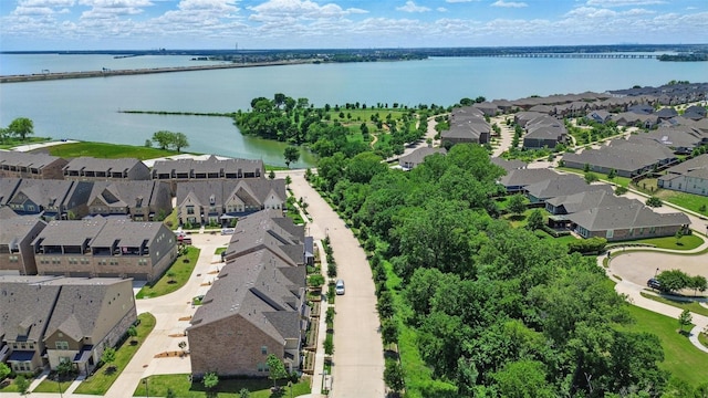 aerial view of residential area featuring a nearby body of water