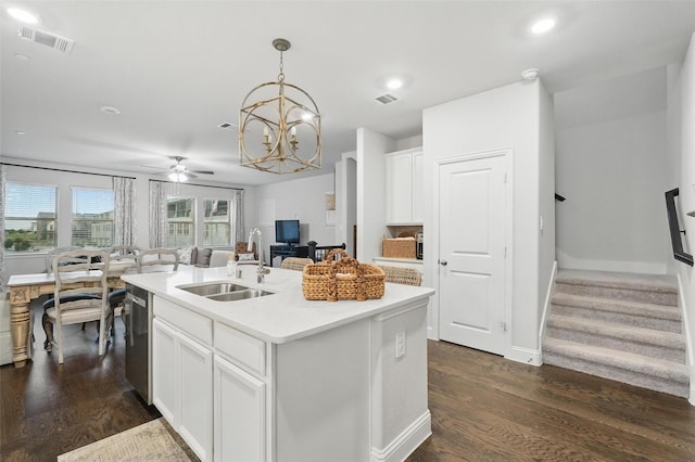 kitchen featuring a sink, stainless steel dishwasher, dark wood-style floors, a chandelier, and recessed lighting