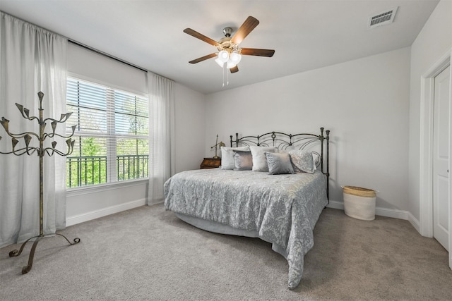 bedroom featuring carpet, baseboards, a ceiling fan, and a chandelier