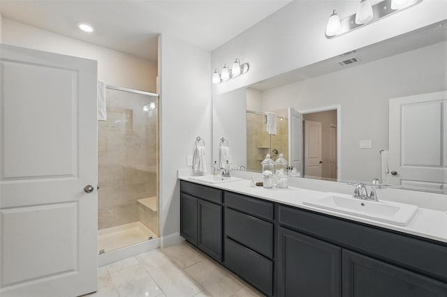 full bathroom featuring a stall shower, tile patterned floors, and double vanity