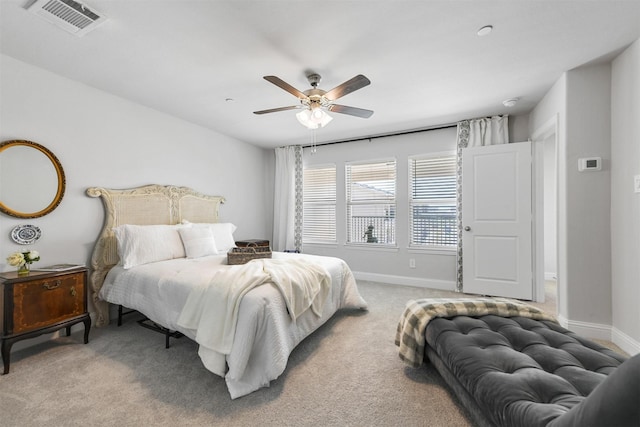 bedroom with light colored carpet, a ceiling fan, and baseboards