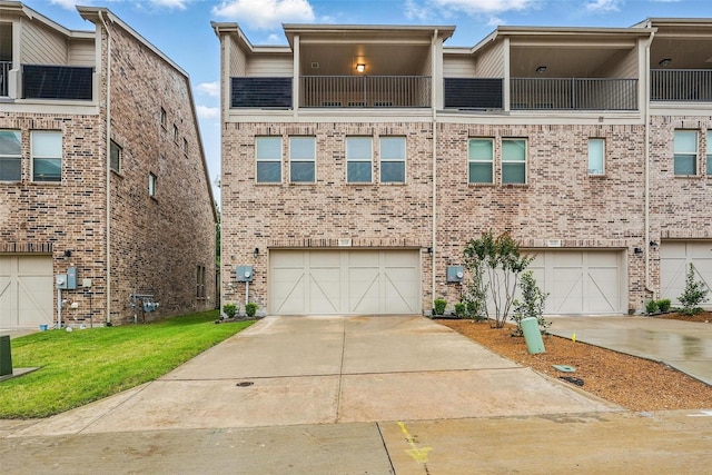 multi unit property with concrete driveway, brick siding, and an attached garage