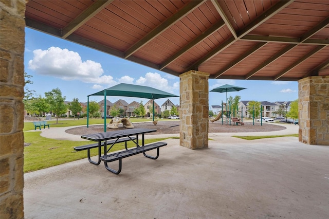 view of property's community with a playground and a yard
