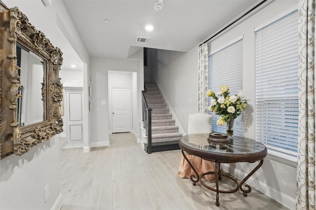 entrance foyer with baseboards, stairway, light wood-style flooring, and recessed lighting