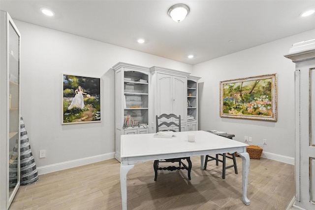 office space with baseboards, light wood-type flooring, and recessed lighting