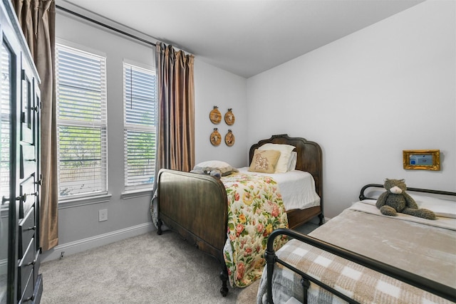 carpeted bedroom featuring baseboards