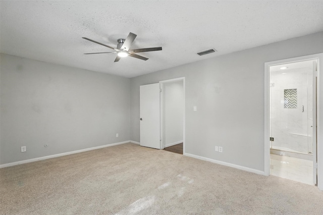 9826 Bent Branch Ln, Dallas, TX 75243 - unfurnished bedroom with carpet floors, baseboards, ensuite bath, and a textured ceiling