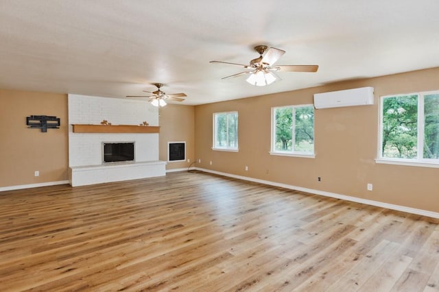 1941 State Highway 59 S, Bowie, TX 76230 - unfurnished living room with a wall mounted air conditioner, light wood-type flooring, baseboards, and a ceiling fan