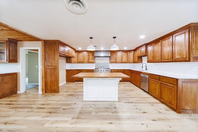 1941 State Highway 59 S, Bowie, TX 76230 - kitchen featuring stainless steel dishwasher, a sink, brown cabinets, light wood-type flooring, and stove